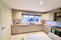 Modren Gray hand painted kitchen cupboards with wooden worktops in castlerock