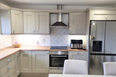  Gray hand painted kitchen cupboards with wooden worktops in castlerock