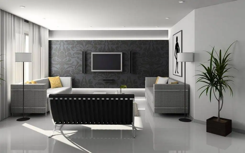 Modren living living room with a dark feature wall with  a tv monted in the middle with light gray sofas 