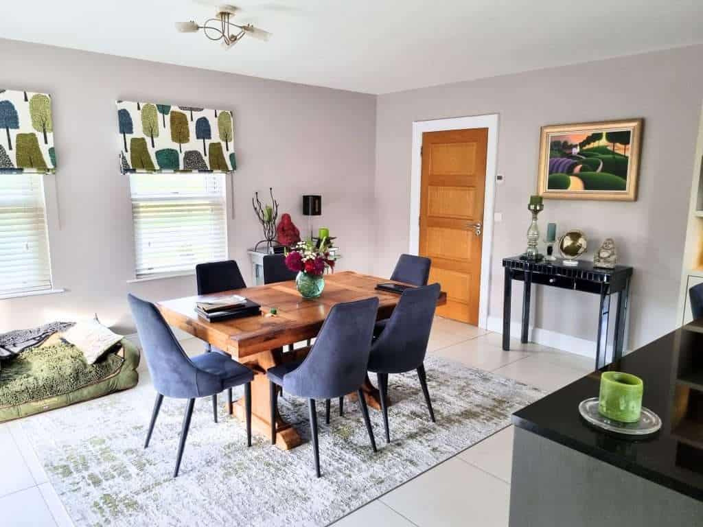 Vibrant interior painting in a stylish dining room featuring neutral wall colors, modern decor, and colorful accents, showcasing professional interior painting services in Portstewart.