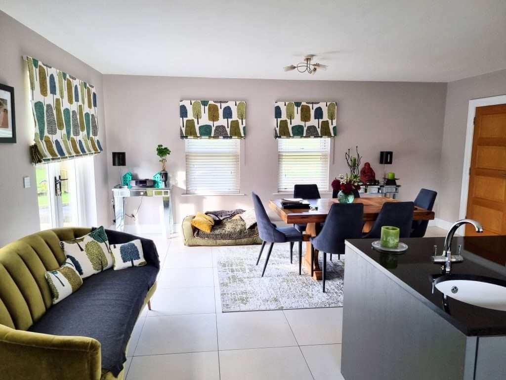 Bright interior of a modern living and dining area with freshly painted walls, featuring stylish window coverings and contemporary decor, showcasing professional interior painting services in Portstewart.