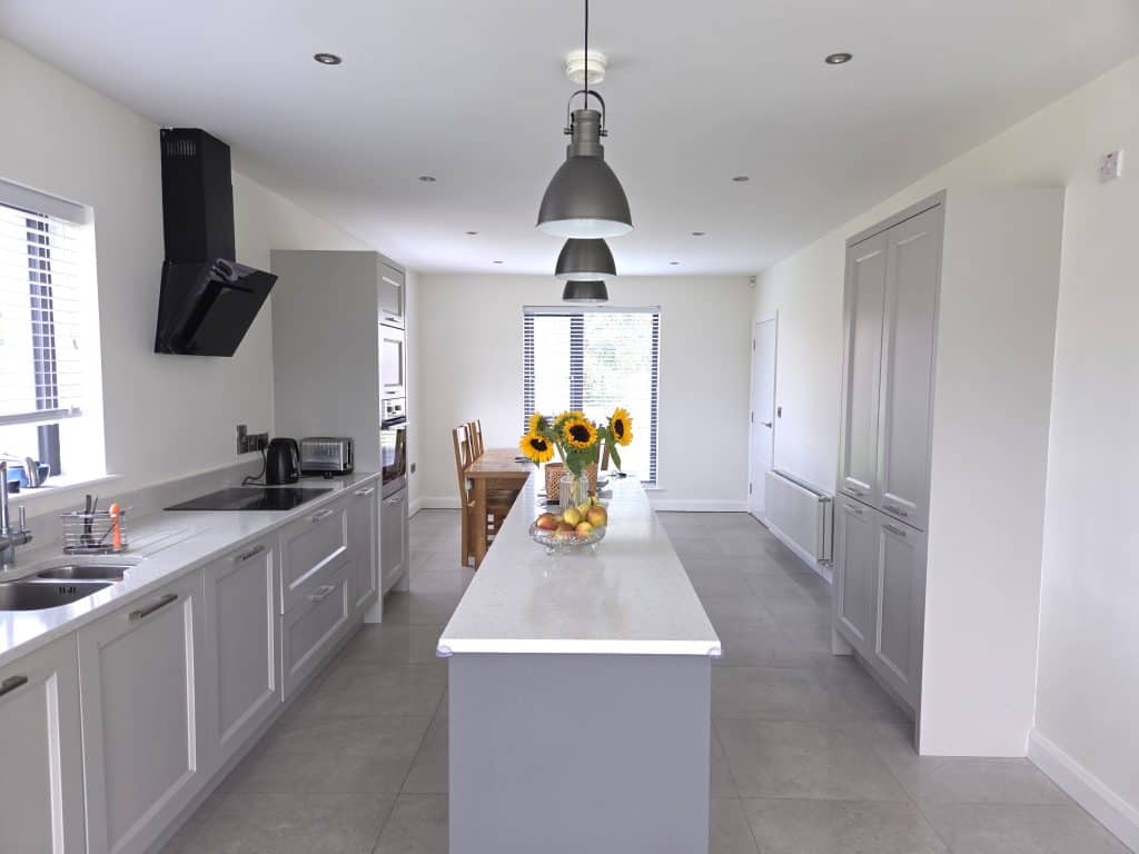 Bright white interior kitchen painted by expert painters in Portstewart, showcasing modern cabinetry, sleek countertops, and fresh wall finishes for a clean, contemporary look.