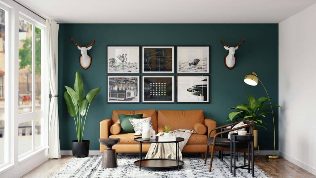 Vibrant teal accent wall in a modern living room painted by G&E Interior Painting in Portstewart. Featuring stylish decor, large plants, and contemporary artwork, showcasing expert interior painting services.